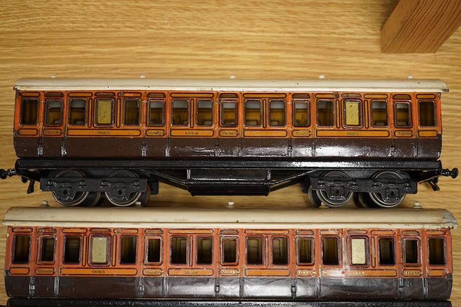 Three Carette for Bassett-Lowke 0 gauge railway 1921 series tinplate LSWR bogie coaches fitted with Bing couplings; two First Third Composite coaches, both 1328, and a full brake van, 133, all in salmon and chocolate liv